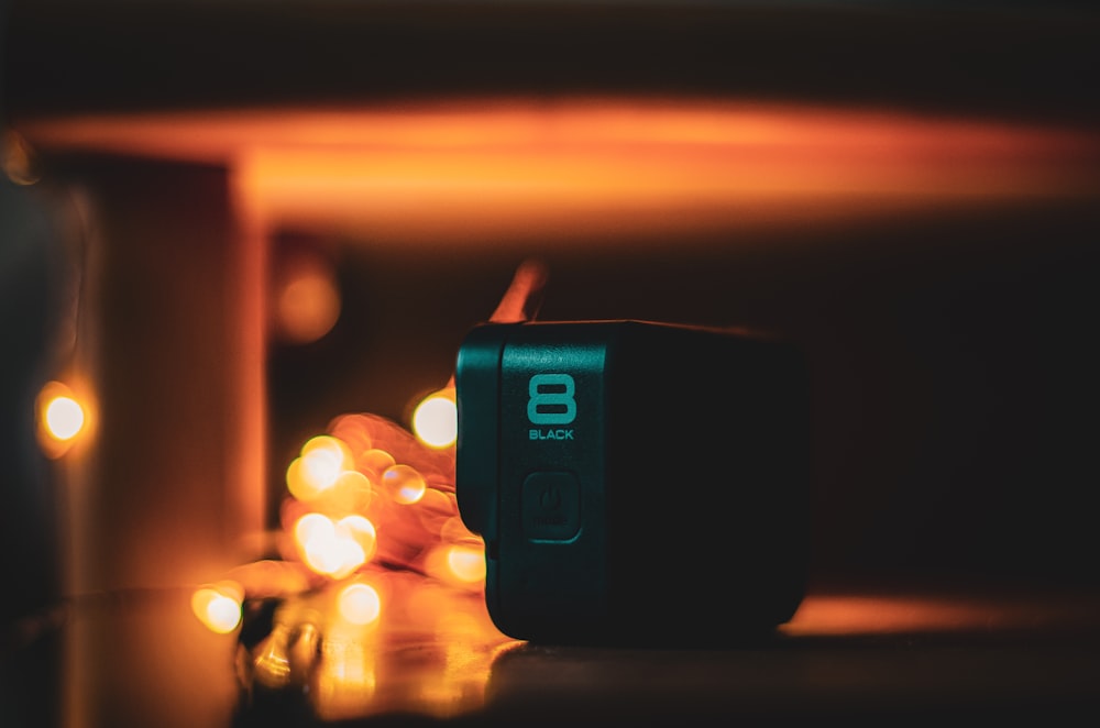 a black speaker sitting on top of a table