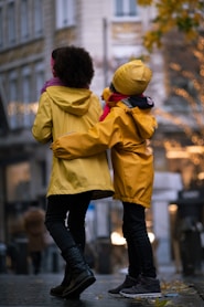 a couple of people that are standing on a sidewalk