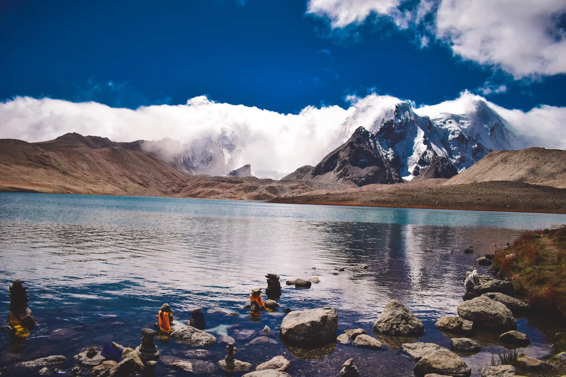 a body of water surrounded by mountains and rocks