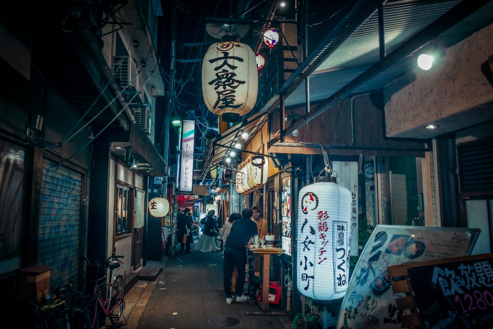 a narrow alleyway with signs hanging from the ceiling