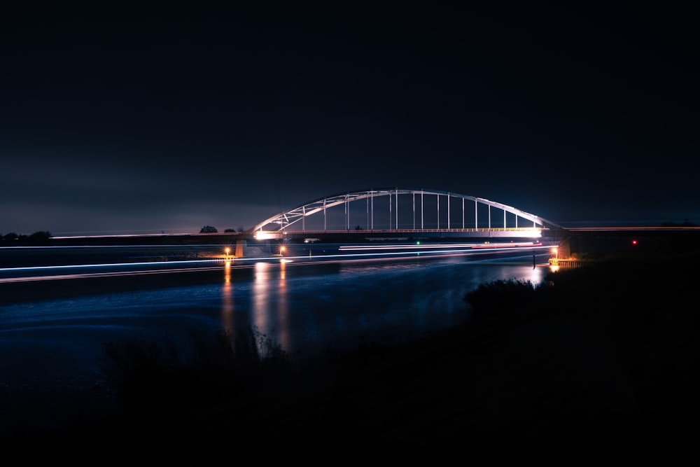 a long exposure photo of a bridge at night