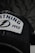 A close-up of a black cap featuring an embroidered patch with the word 'LIGHTNING', a stylized lightning bolt logo, and the number '1992'. The patch has a white background with blue and black embroidery. The cap has mesh detailing visible in the image.