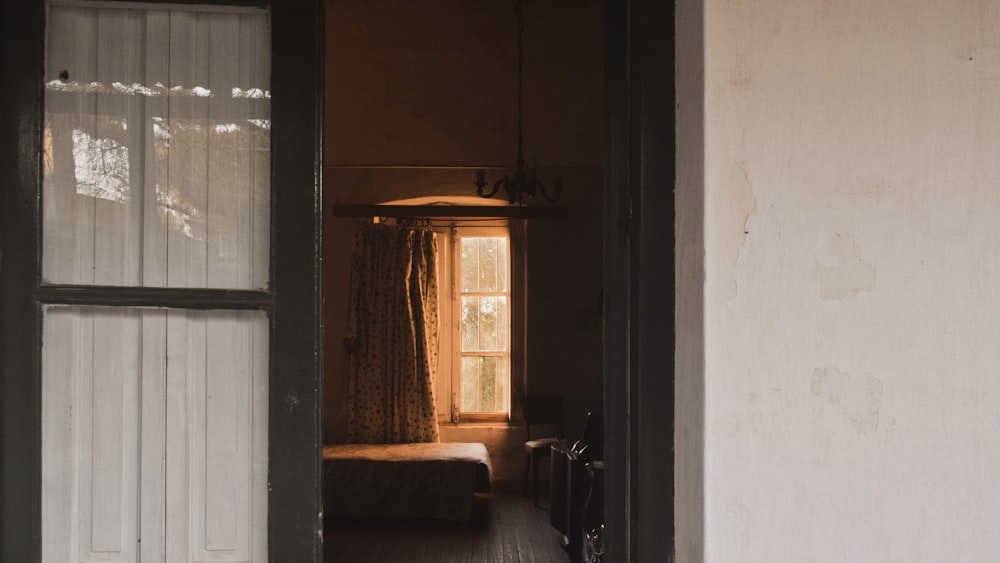 an open door leading to a bedroom with a bed