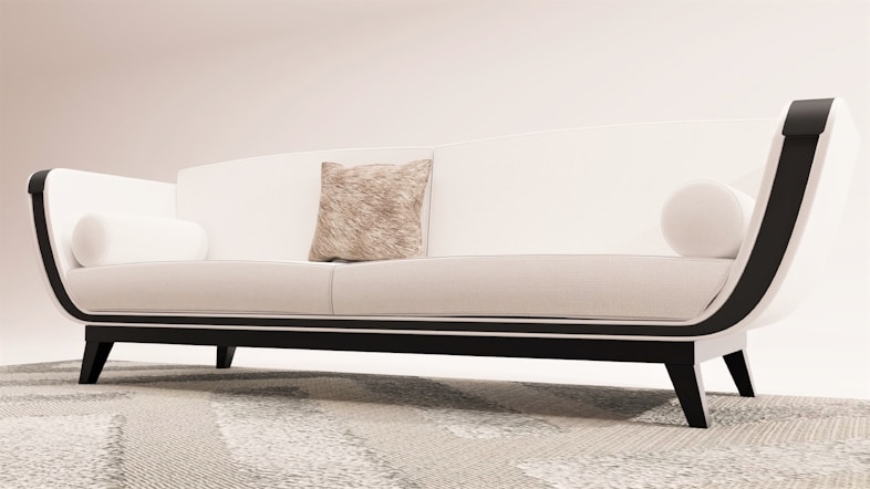 a white couch sitting on top of a rug