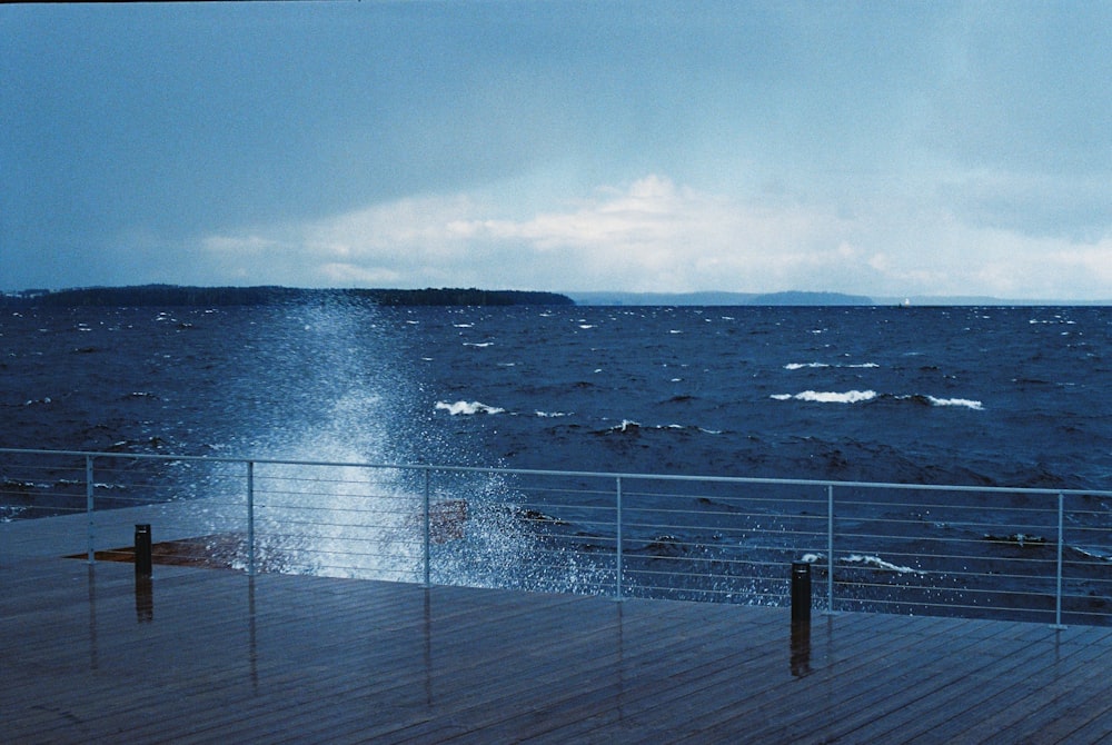 a large body of water sitting next to a wooden pier