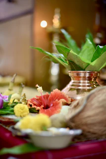 A festive arrangement of housewarming gifts featuring temple motifs and vibrant green accents