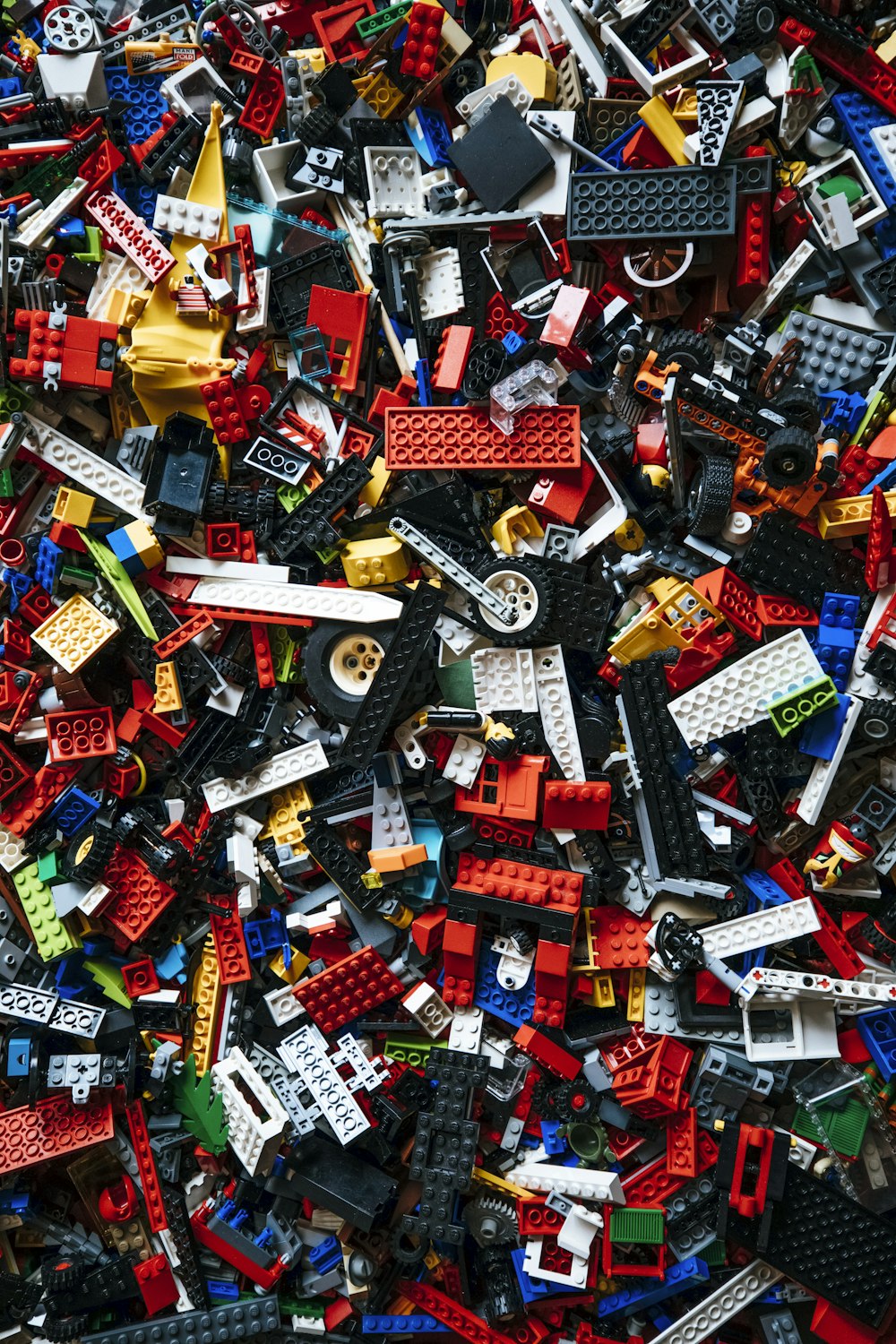 a pile of assorted legos sitting on top of each other