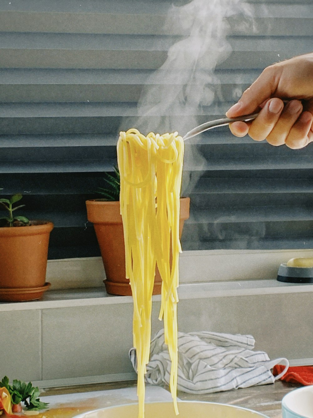 a person is holding a fork full of spaghetti