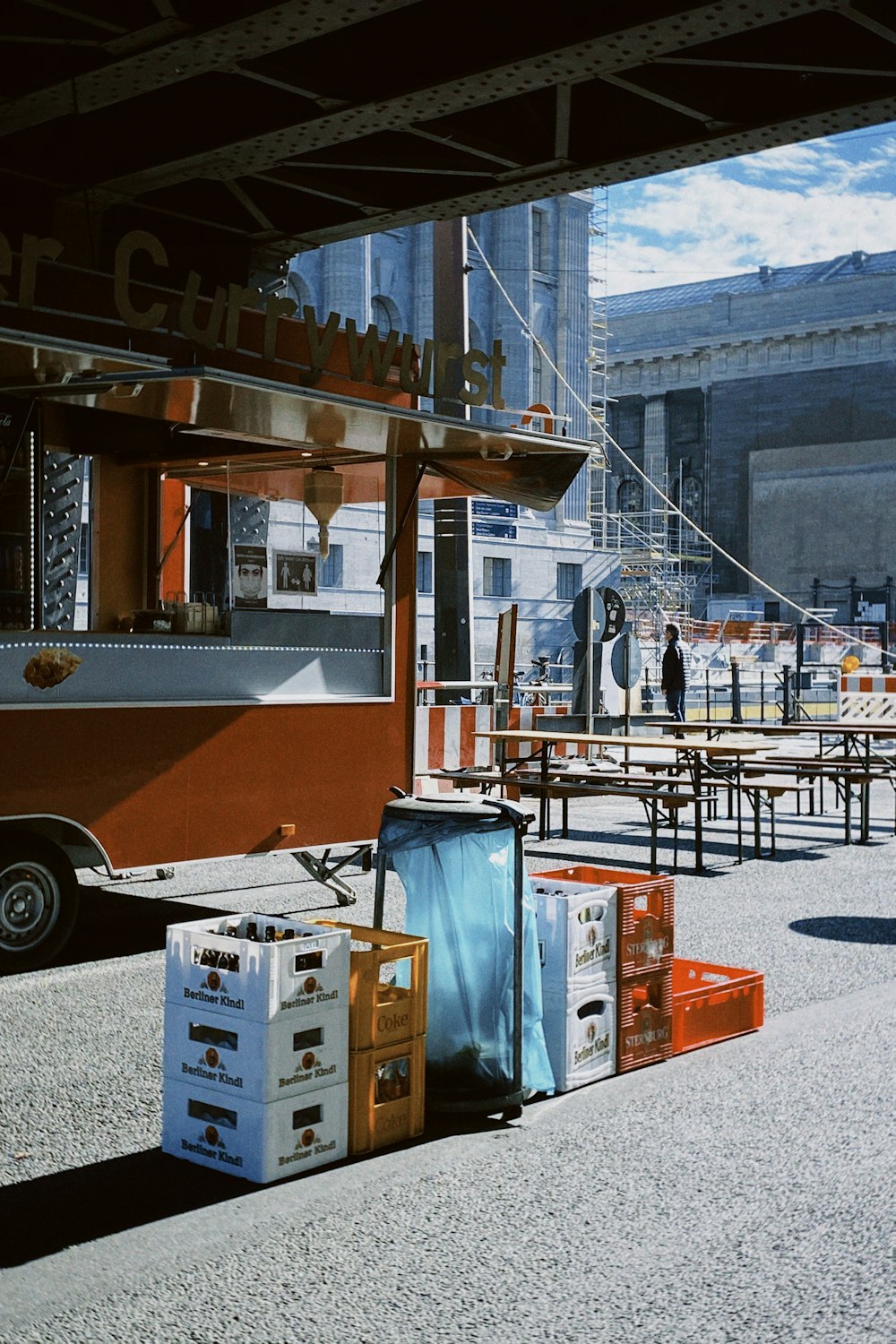 a food truck parked next to tables and chairs