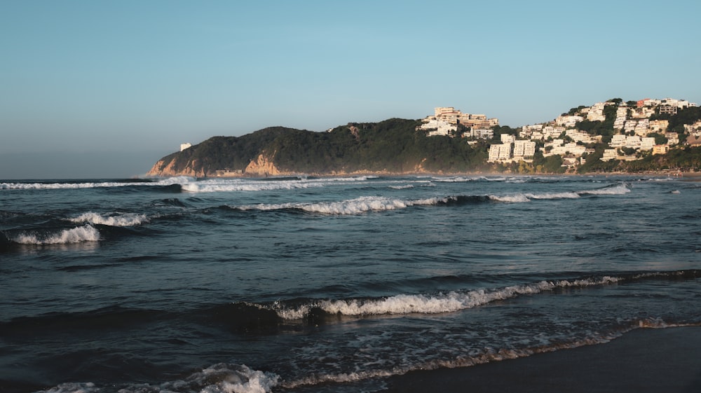 a view of a beach with a city in the background