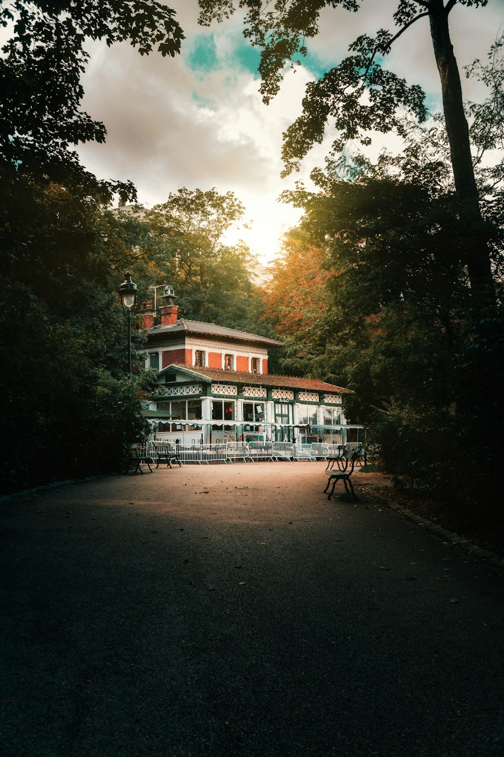 a red building sitting in the middle of a forest