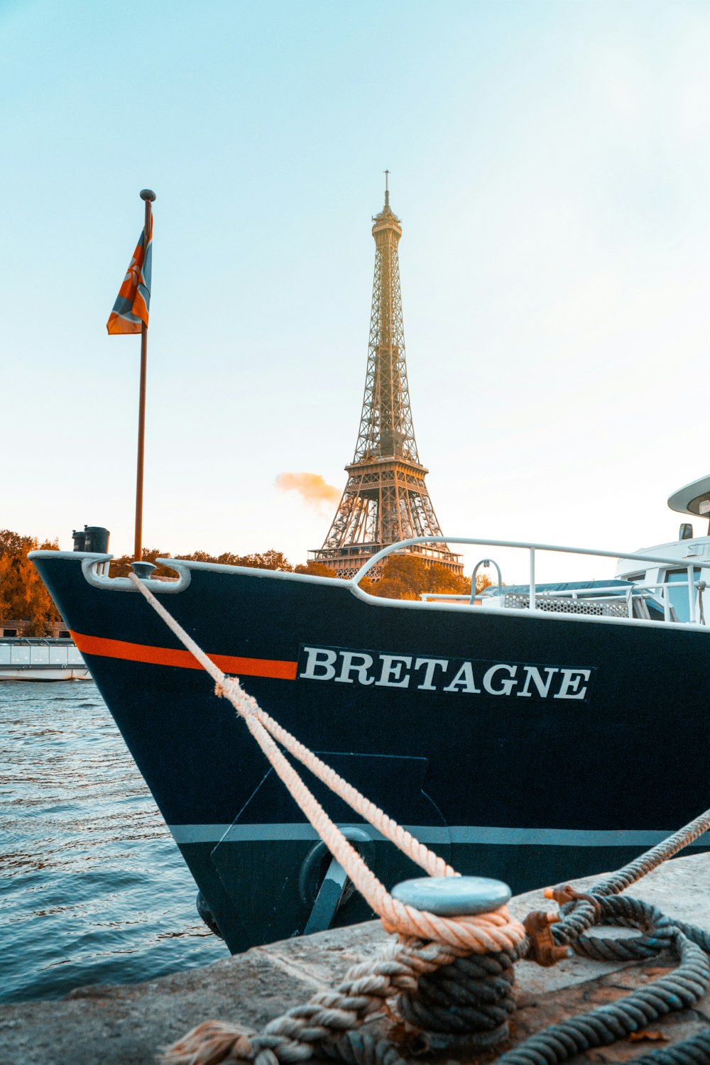 a boat tied to a dock with the eiffel tower in the background