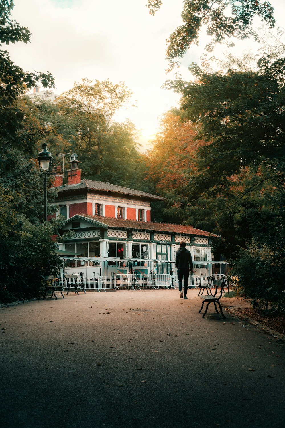 a person standing in front of a red building