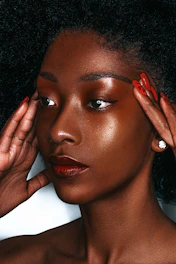 a woman with a red manicure on her nails