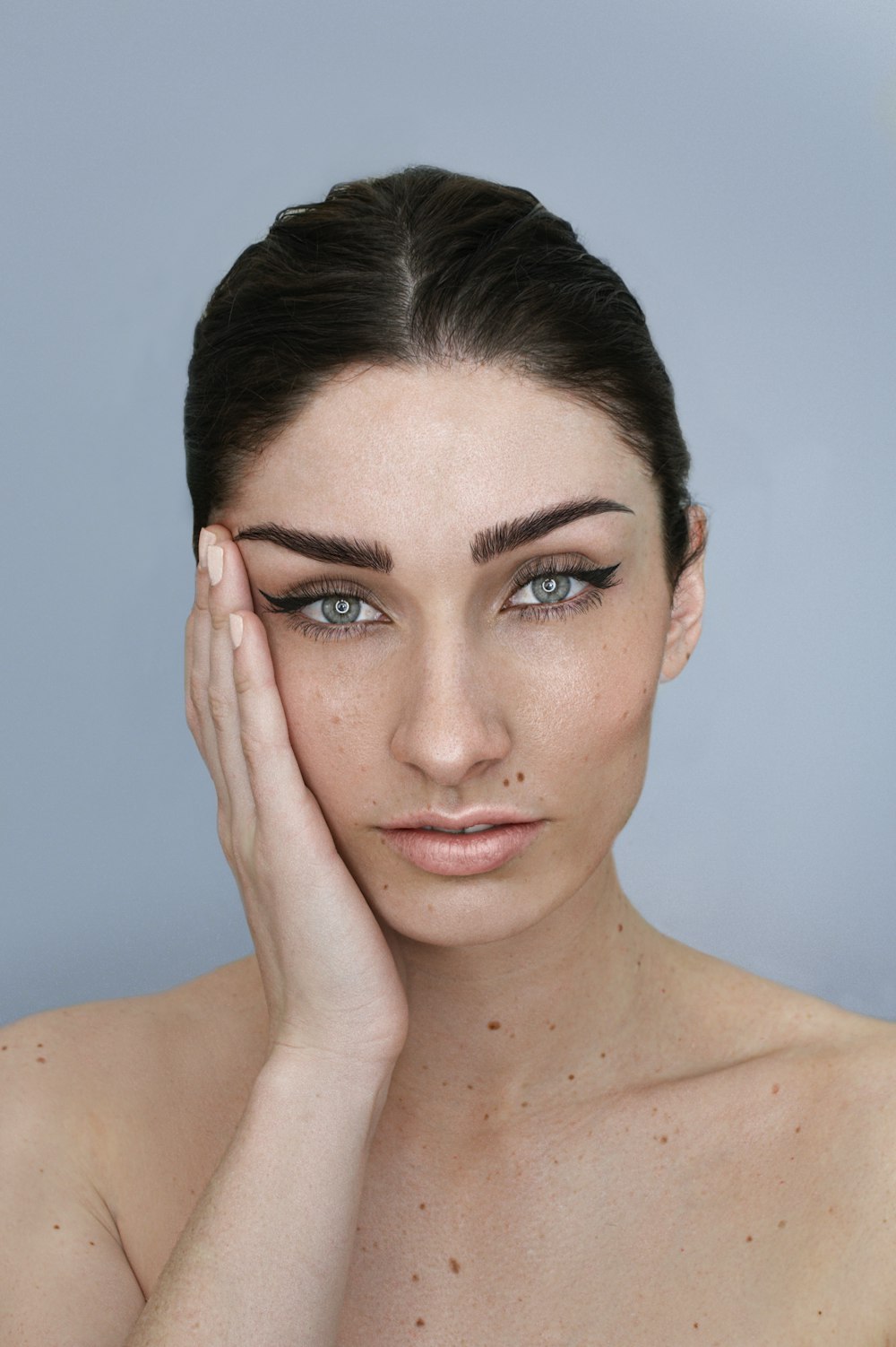 a woman with her hand on her face