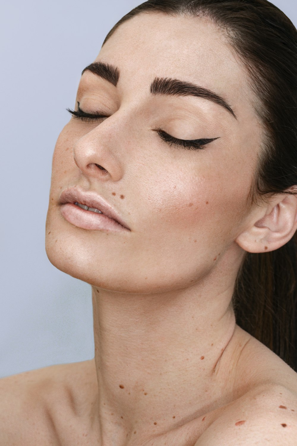 a woman with freckles on her face and neck