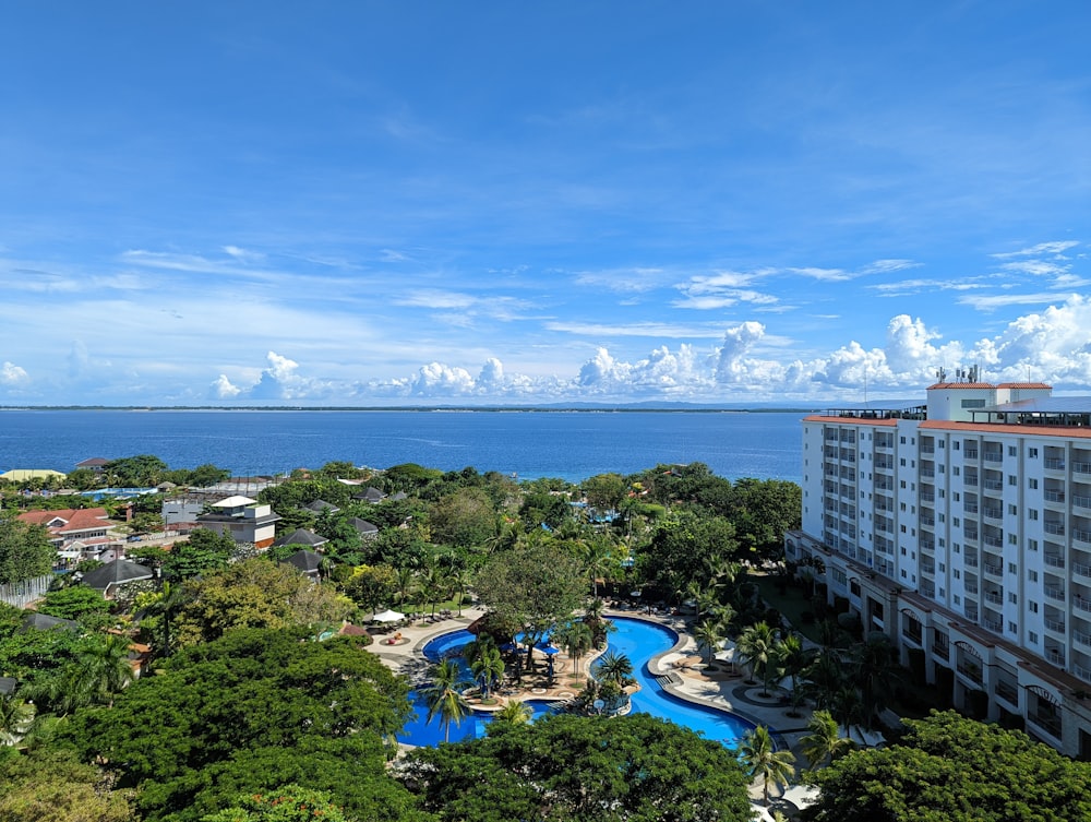 an aerial view of a resort with a pool in the foreground