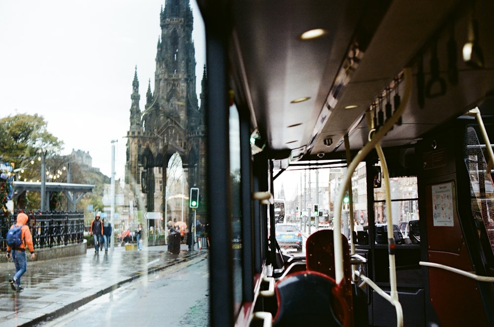 a group of people walking down a street next to a bus