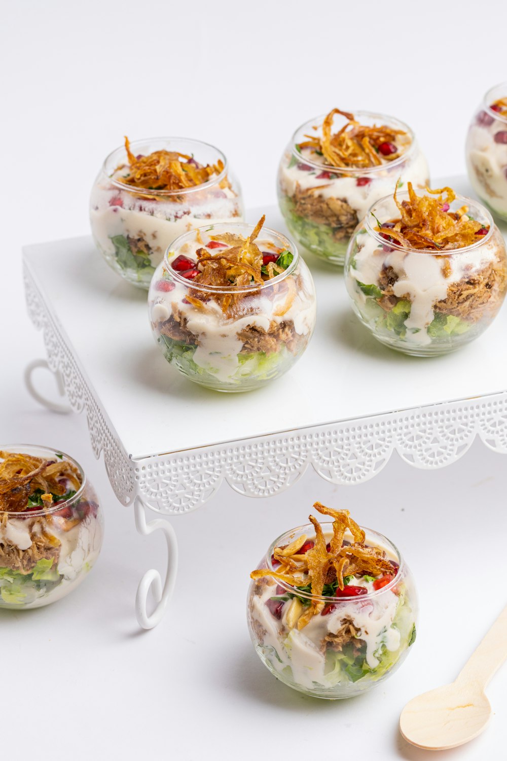 a table topped with bowls of food and a wooden spoon