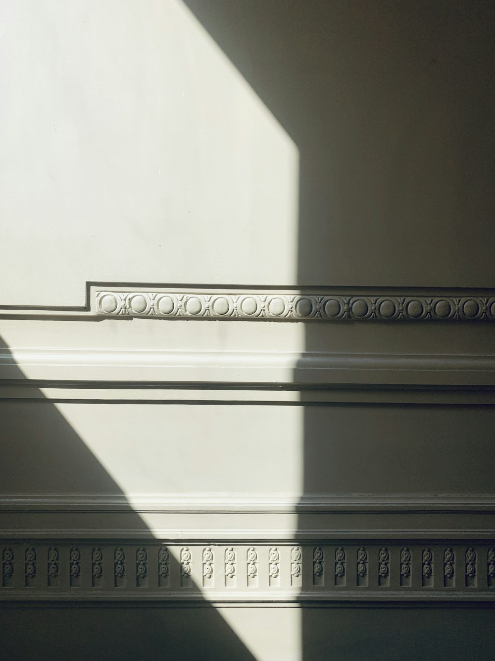 the shadow of a clock on a wall