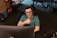 a man wearing headphones sitting in front of a computer