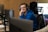 a man wearing headphones sitting in front of a computer