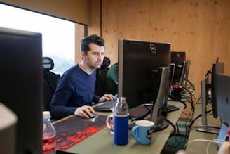 a man sitting at a desk using a computer