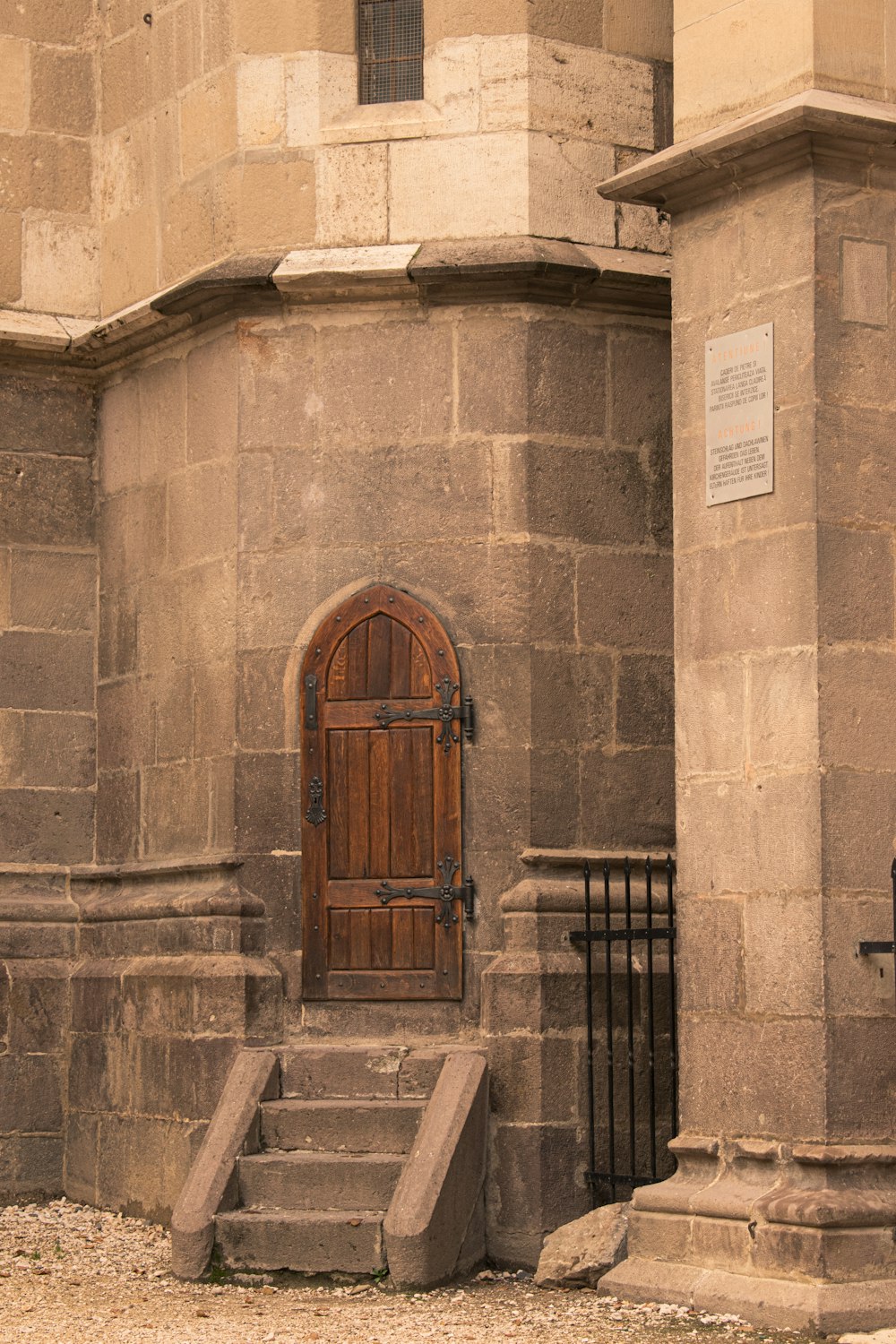 an old building with a wooden door and steps