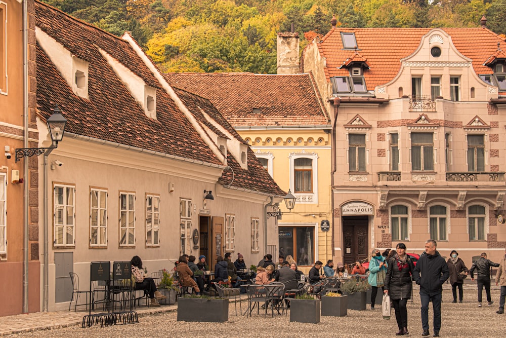 a group of people walking down a cobblestone street