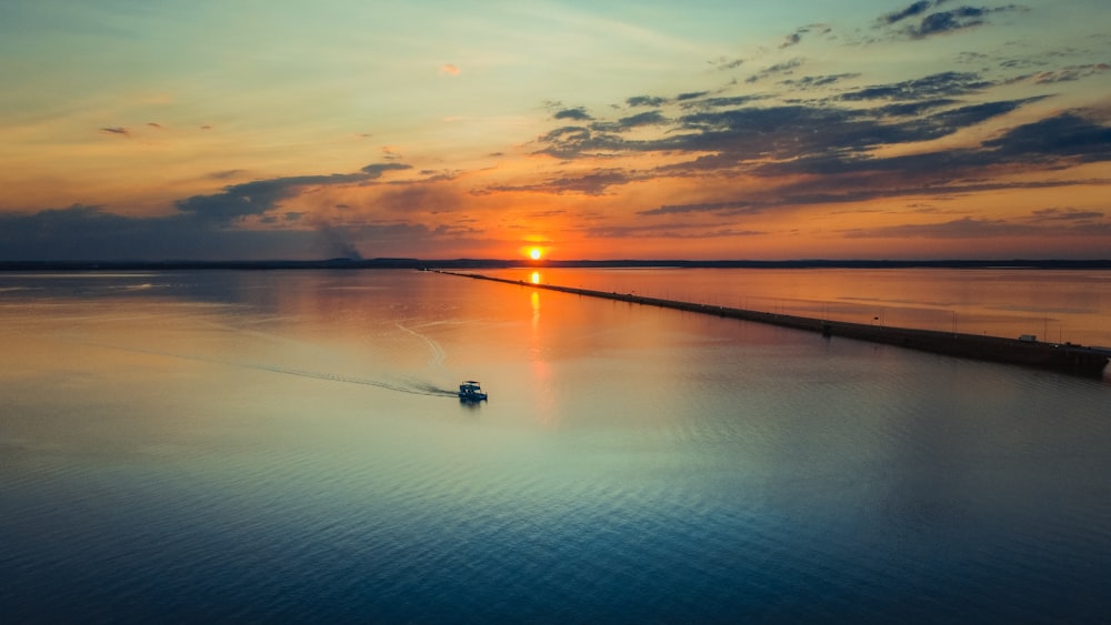 a small boat in the middle of a large body of water