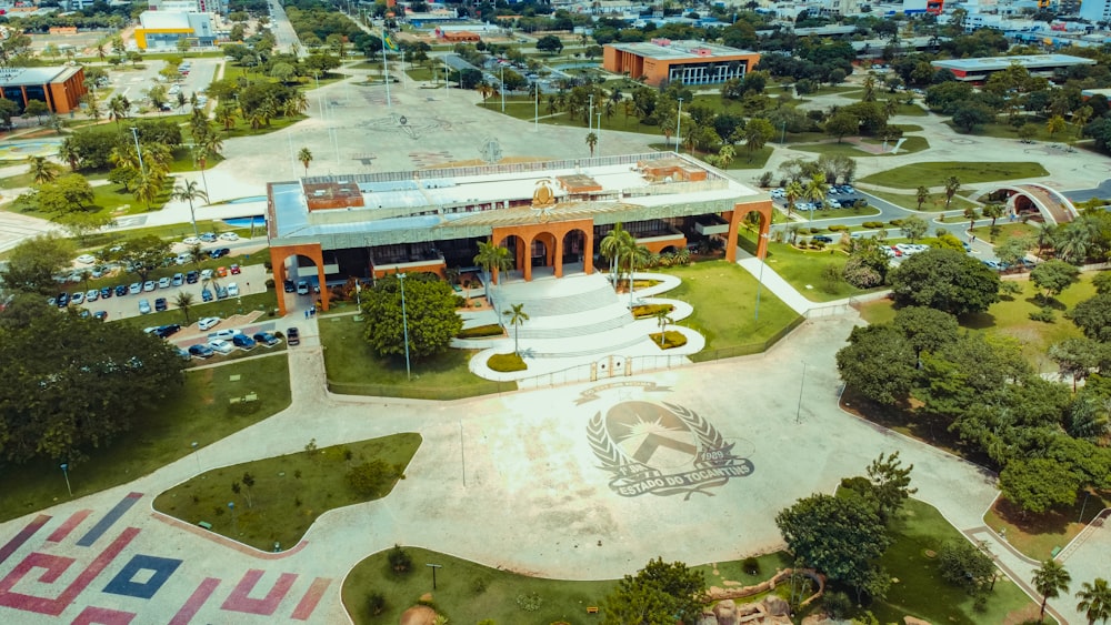 an aerial view of a large building with a lot of trees in front of it