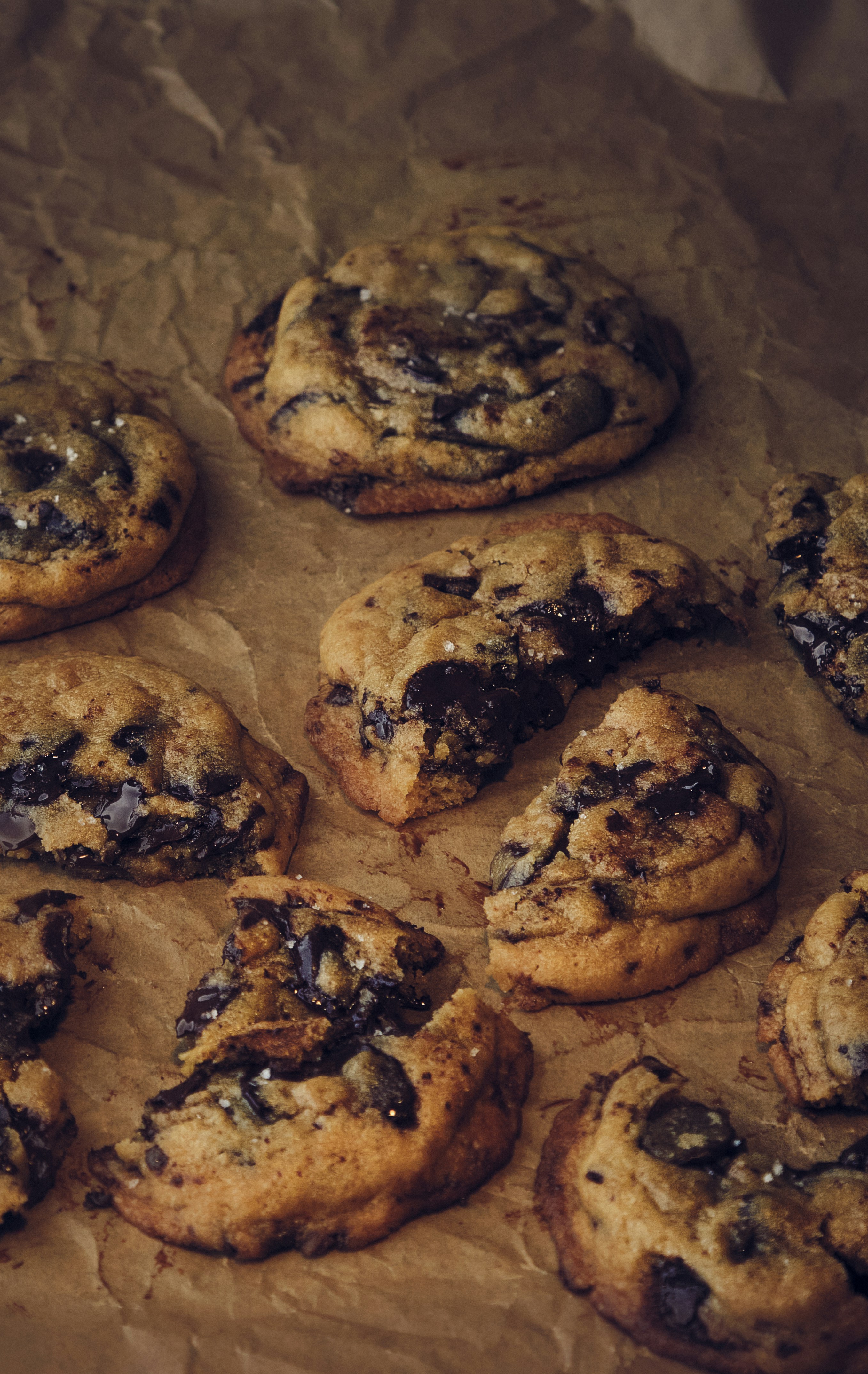 a bunch of cookies sitting on top of a piece of wax paper