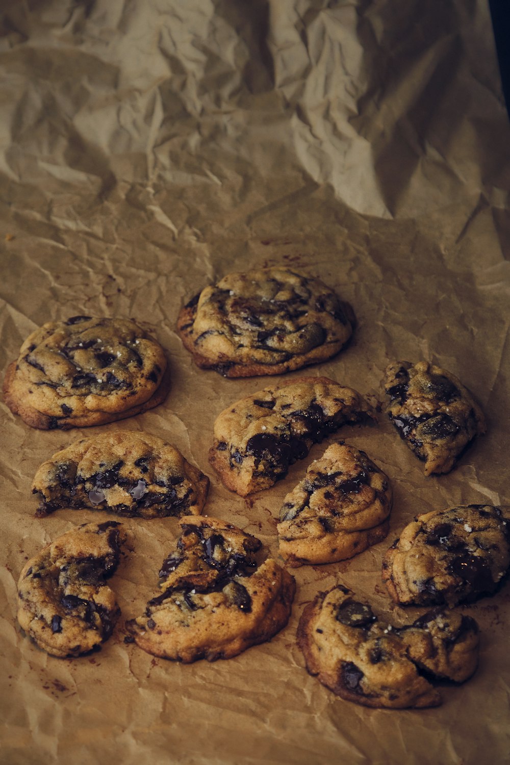 a bunch of cookies sitting on top of a piece of wax paper