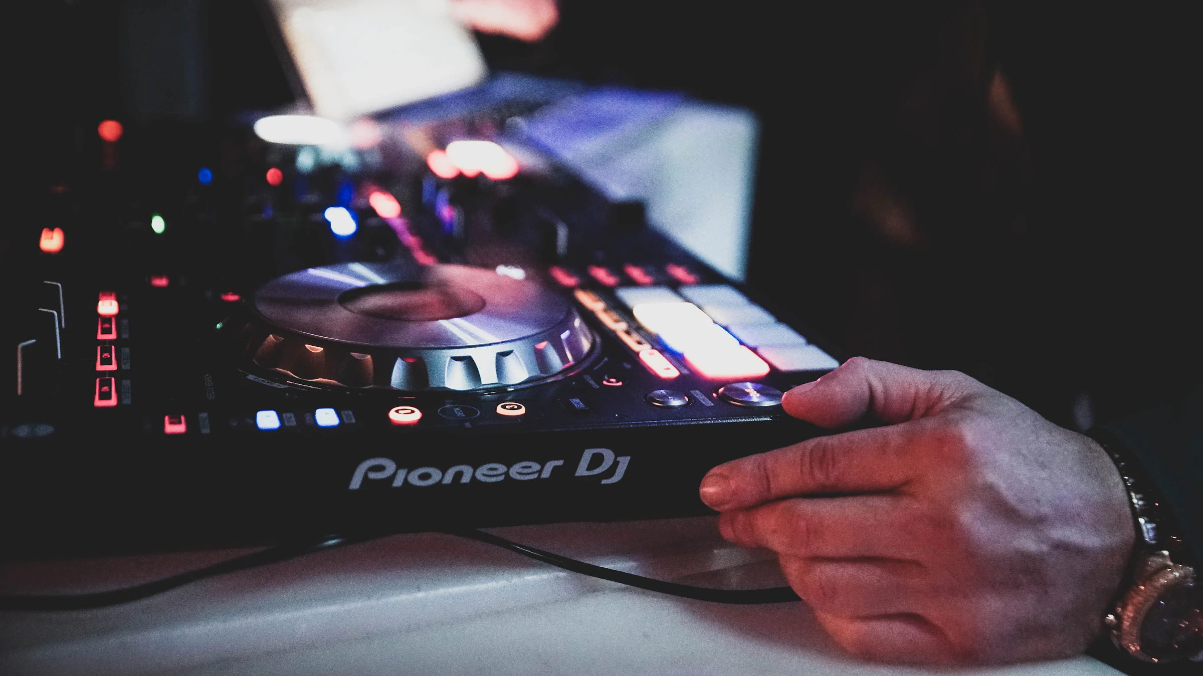A DJ holding a controller