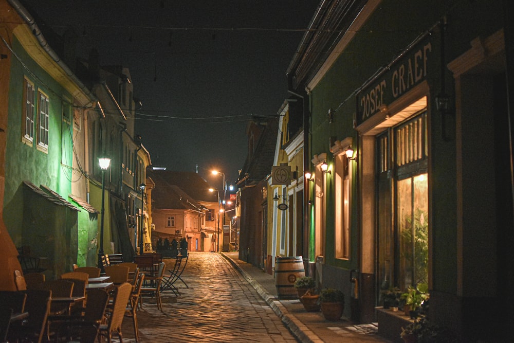 a cobblestone street lined with tables and chairs