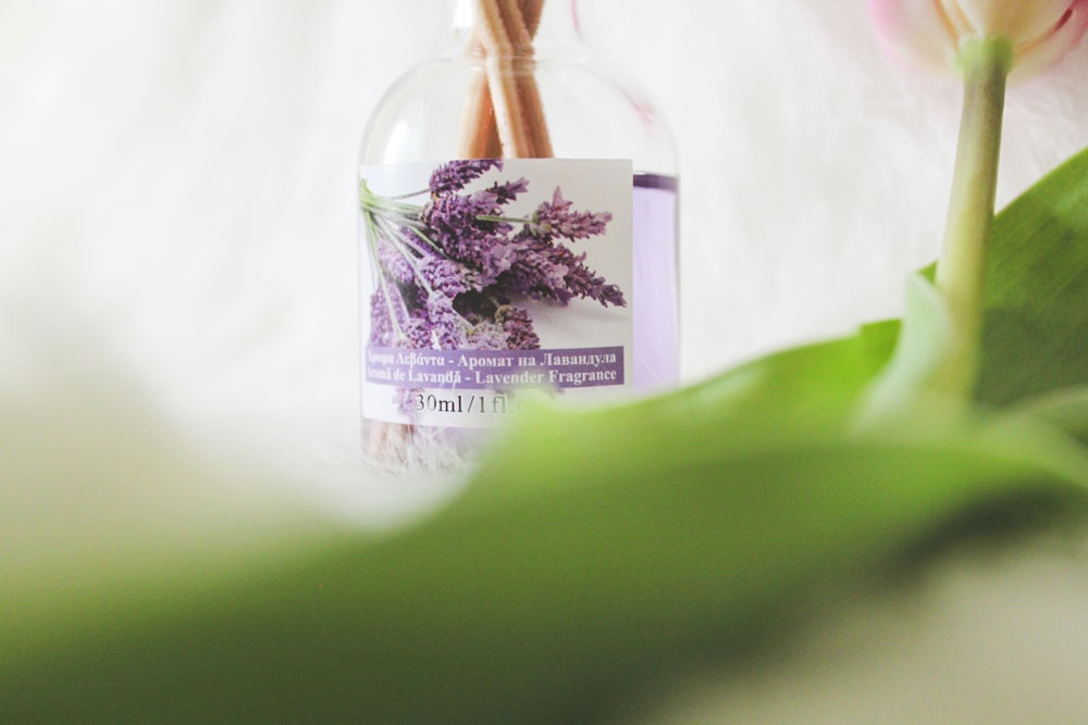 a close up of a bottle with flowers in it