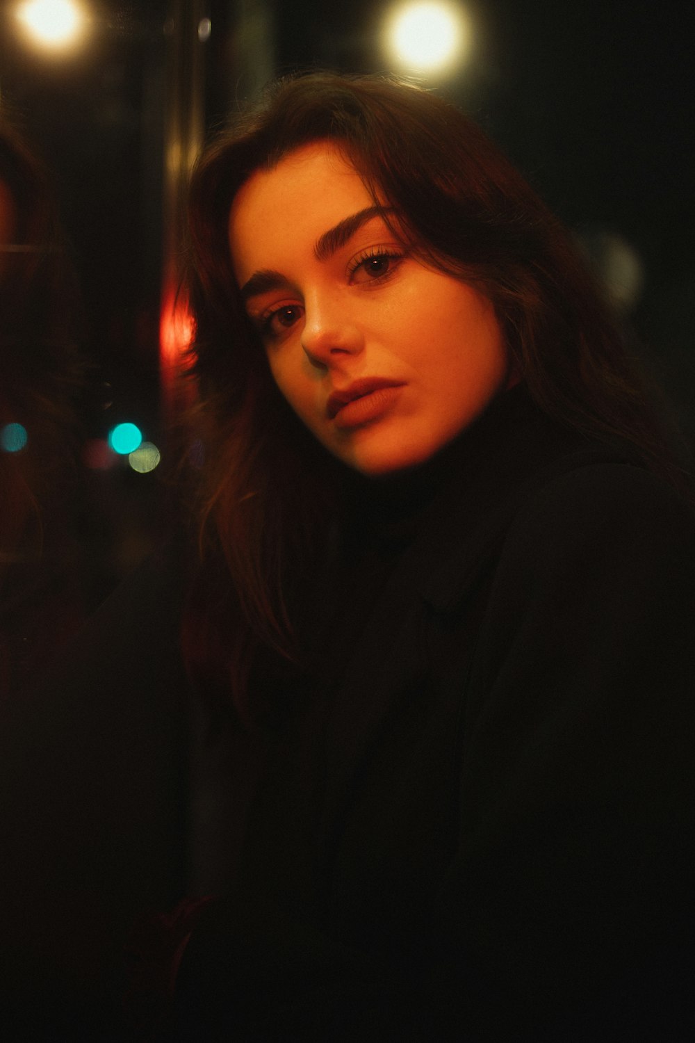 a woman standing in front of a street light