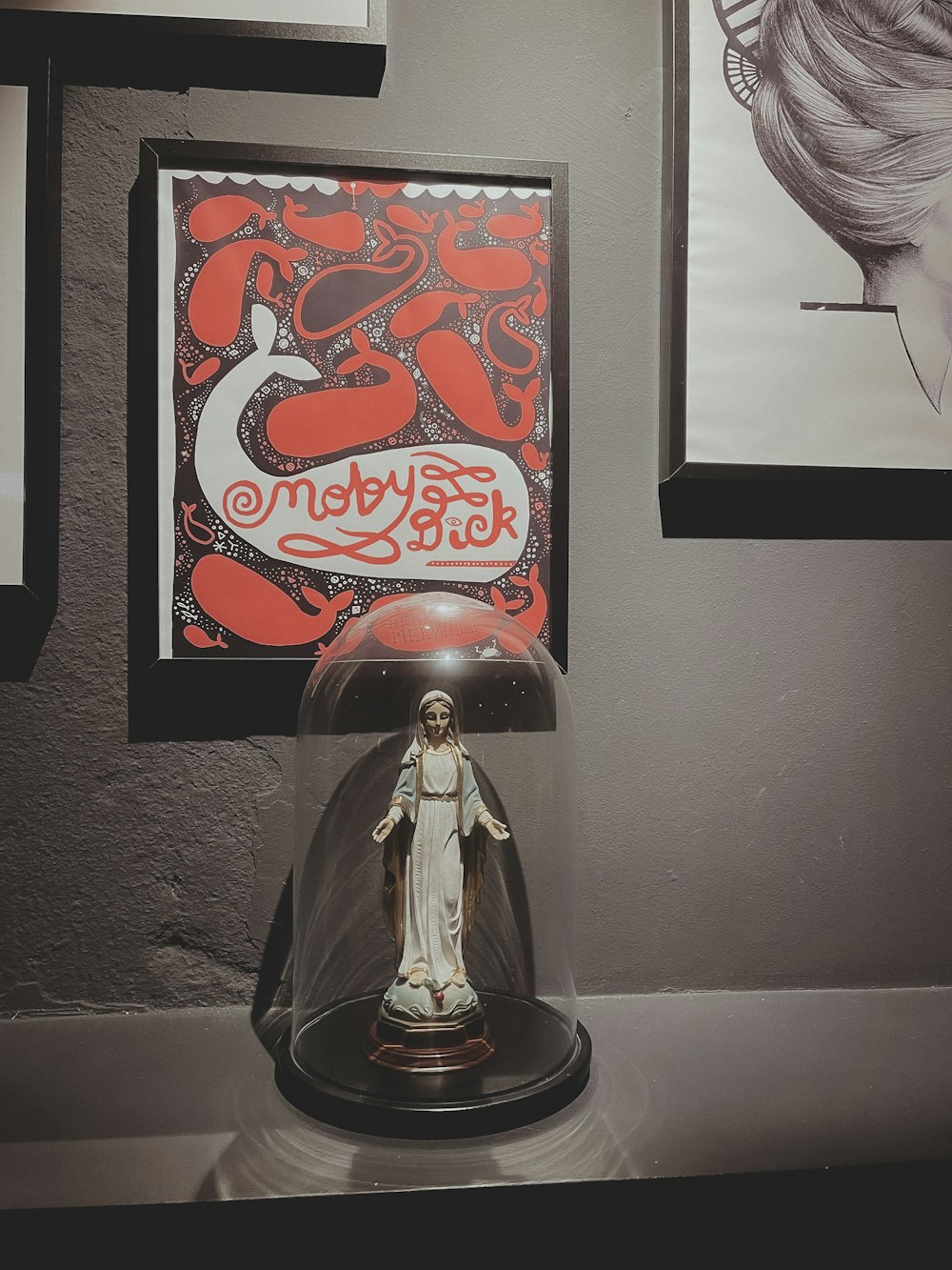 a statue under a glass dome on a table