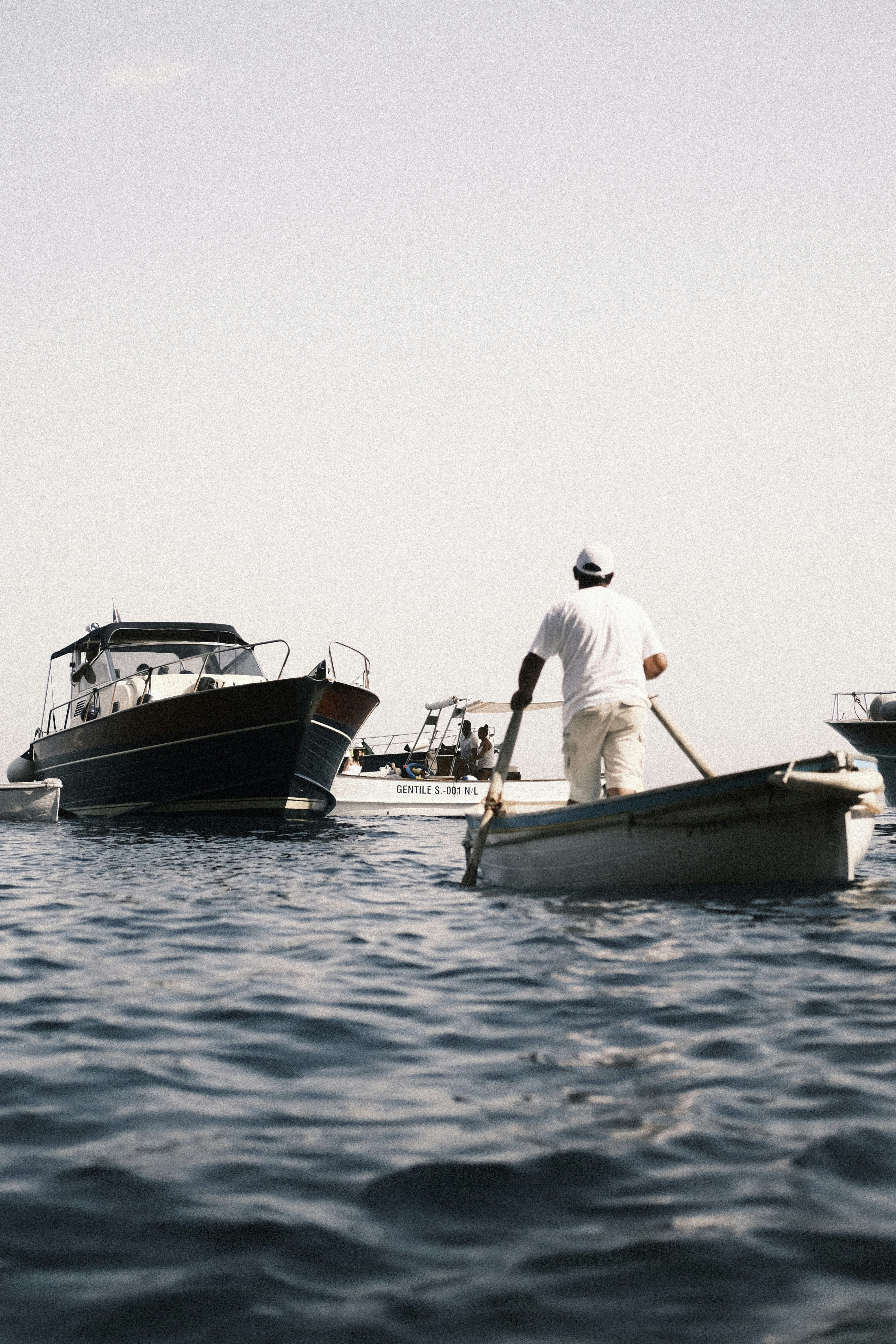 a man rows a row boat in the water