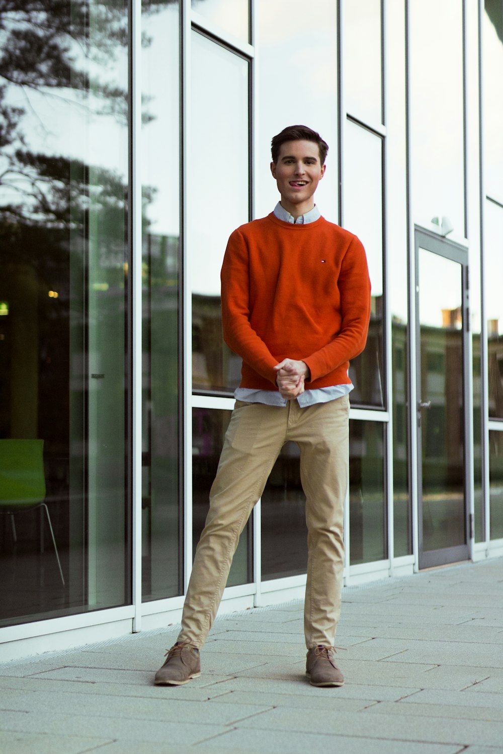 a man standing on a sidewalk in front of a building