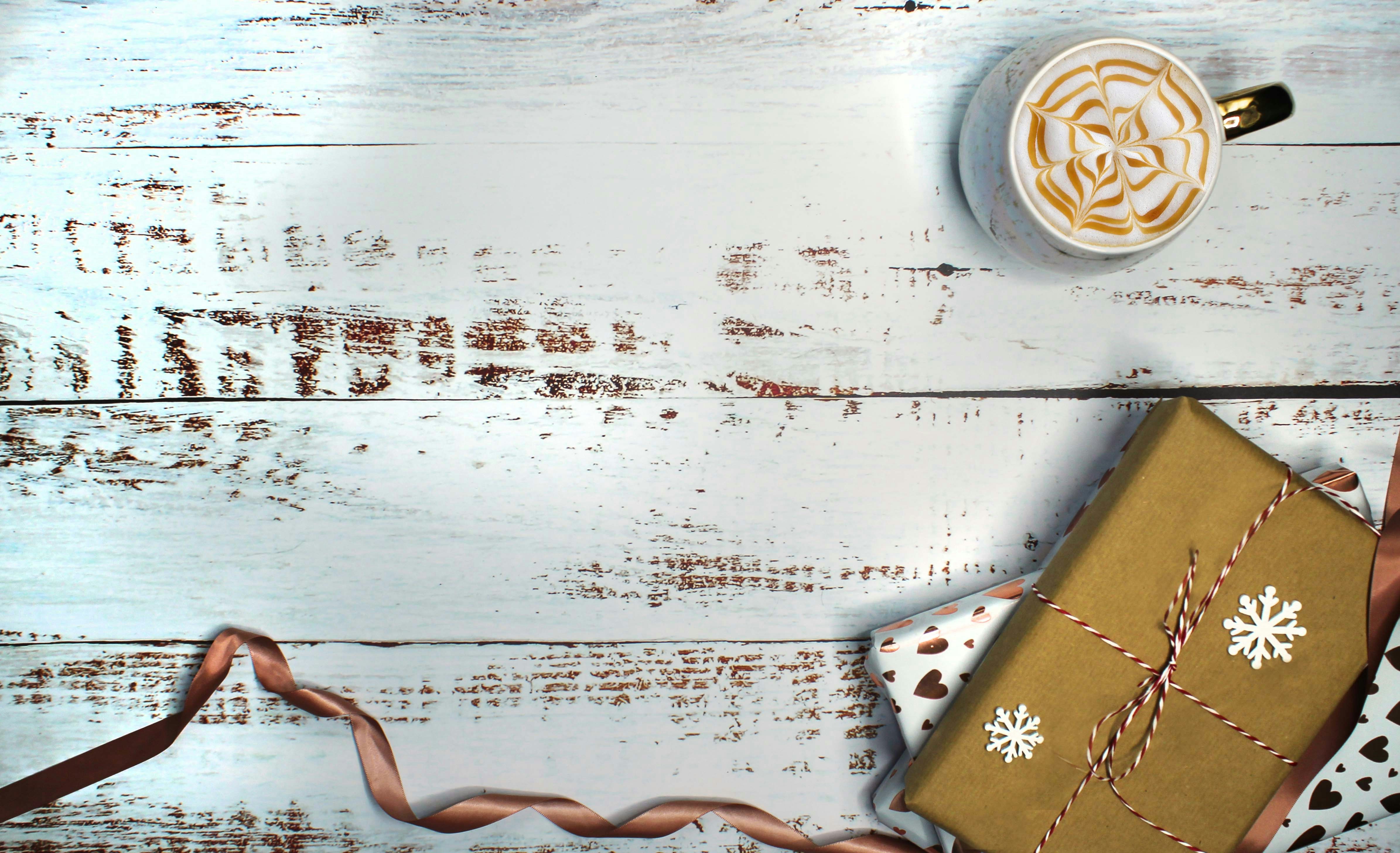 a cup of coffee and a present on a table