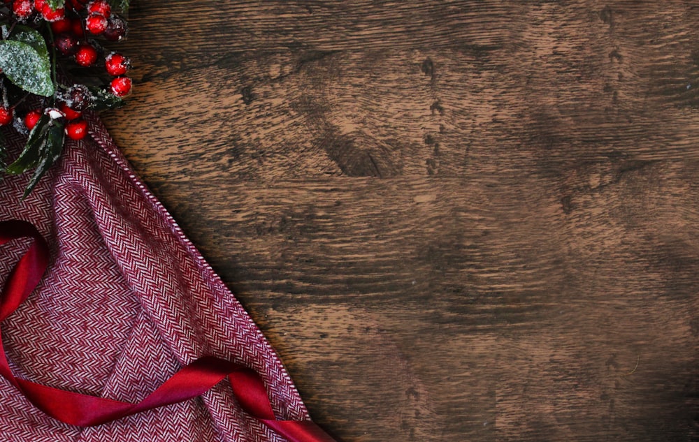 a cloth with a red ribbon on a wooden table