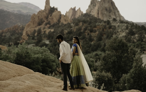 a man standing on a rocky hill