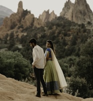 a man standing on a rocky hill