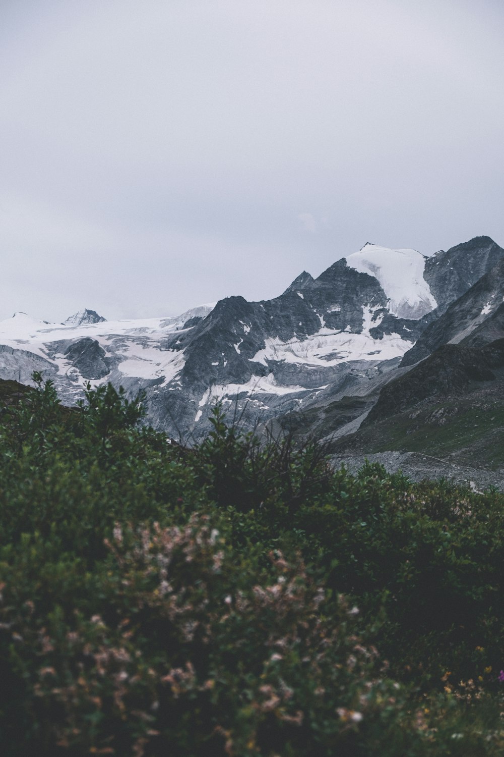 a mountain range with snow covered mountains in the background