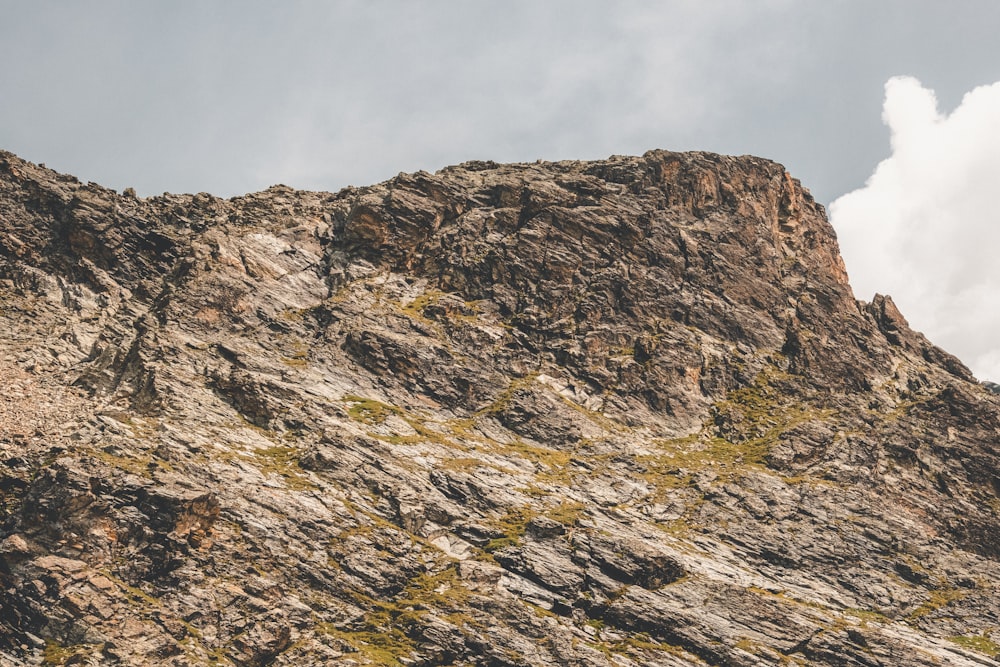 a very tall mountain with a sky in the background