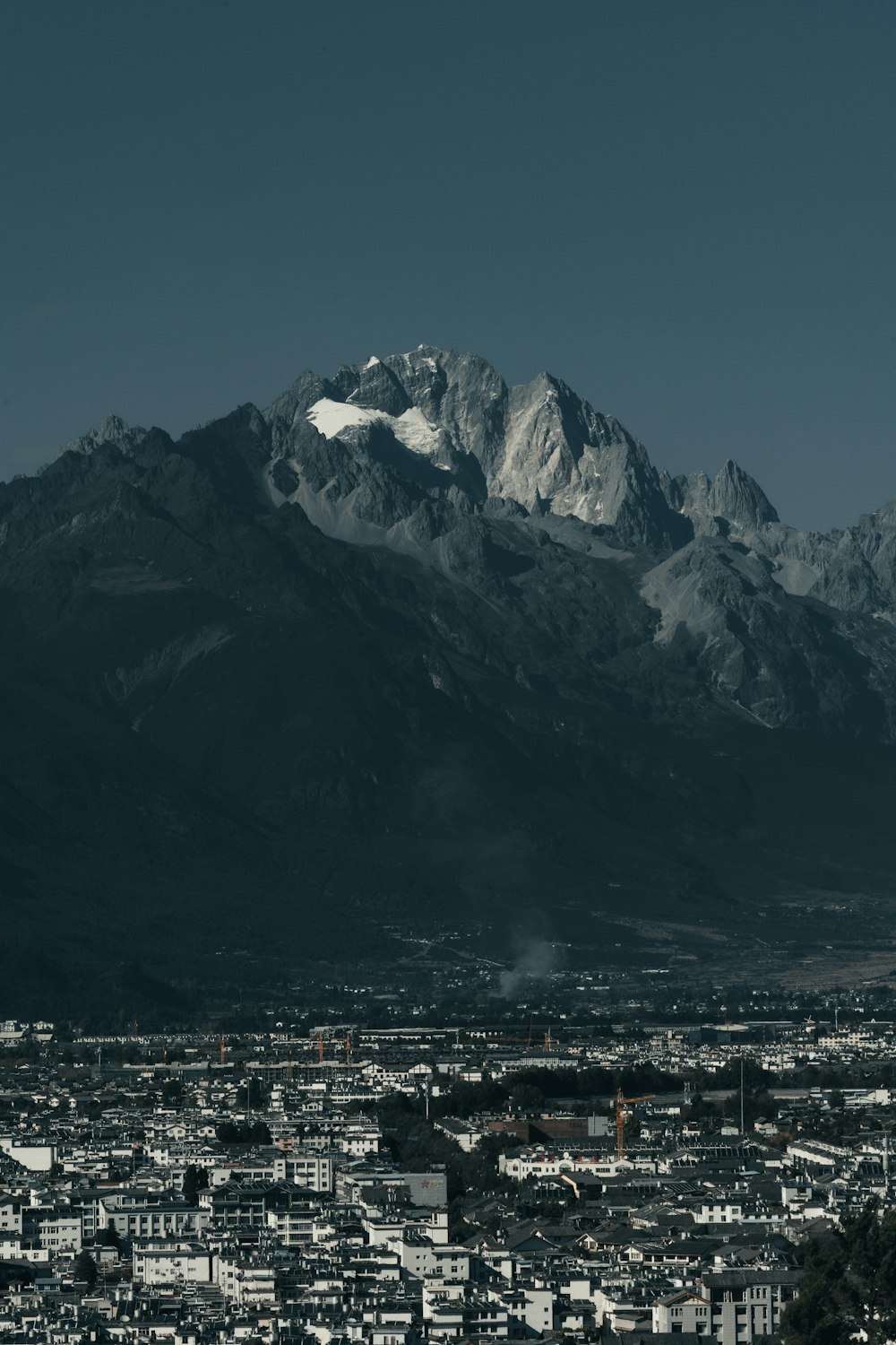 a view of a city with mountains in the background