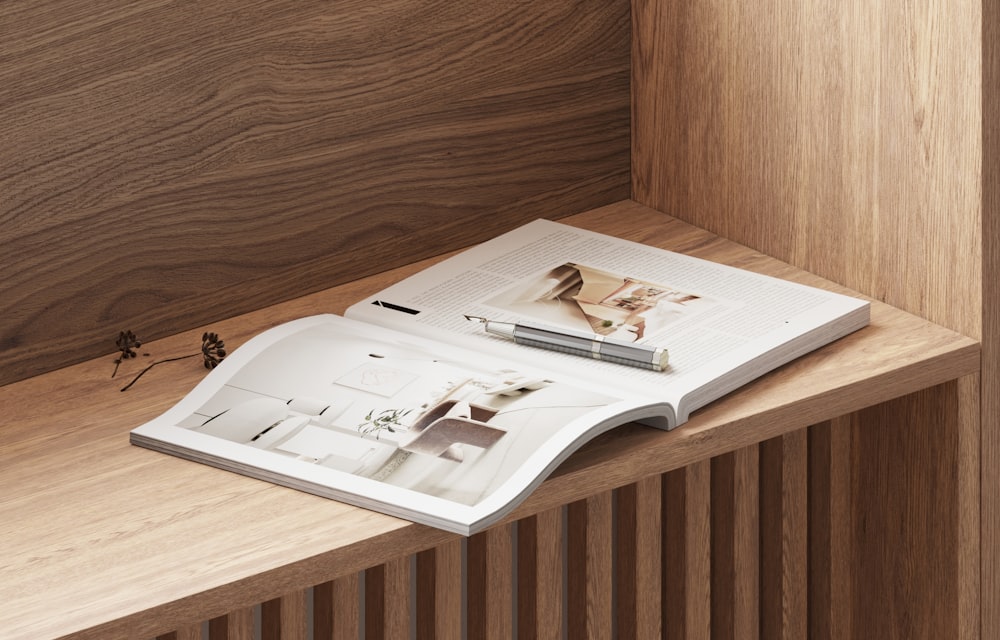 an open book sitting on top of a wooden shelf