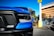 a blue truck parked in front of a building