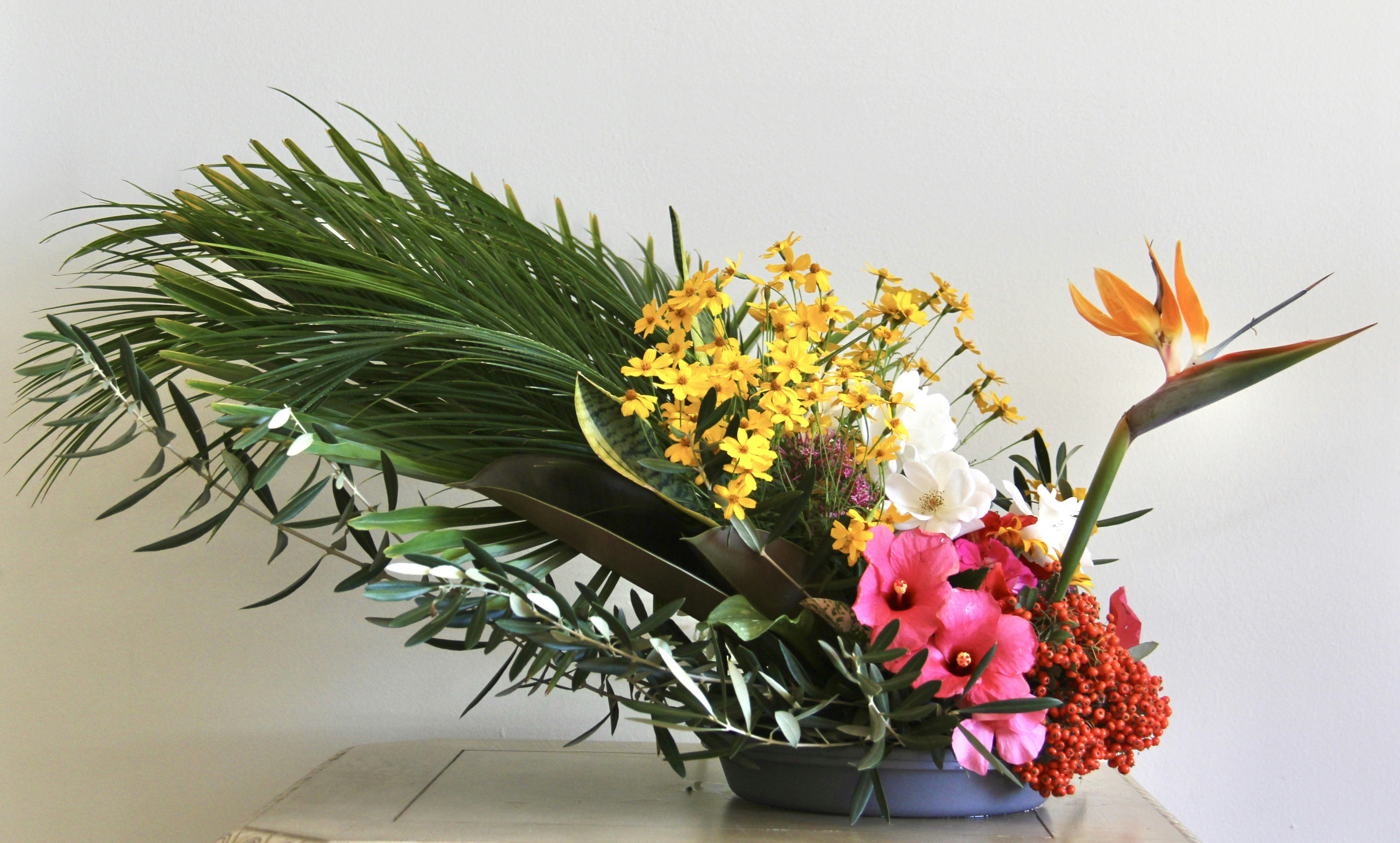 a vase filled with lots of flowers on top of a table